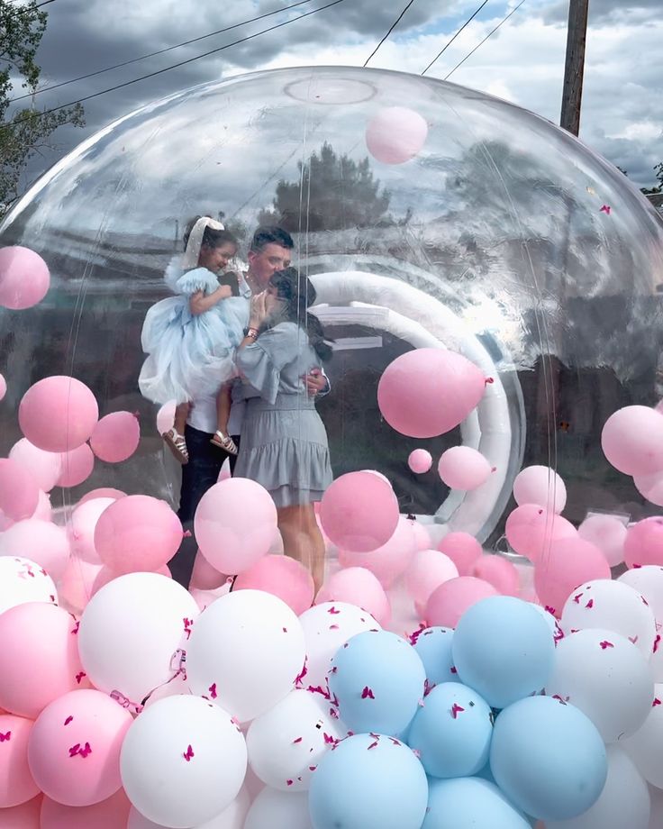 Happy family posing in front of the bubble house