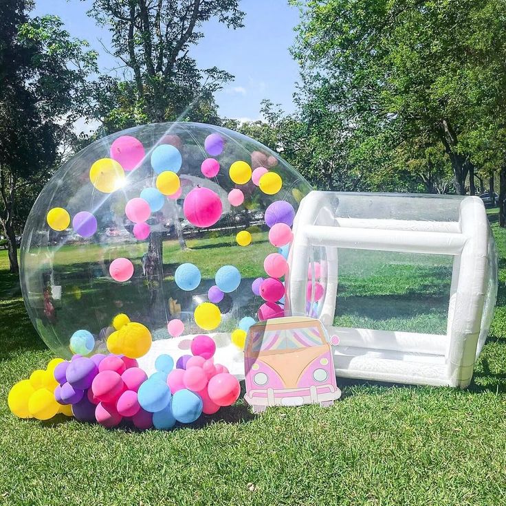 A professional bubble house setup on a lush green lawn